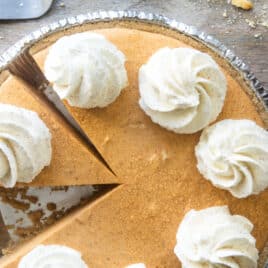 A no-bake pumpkin cheesecake with whipped cream on top.