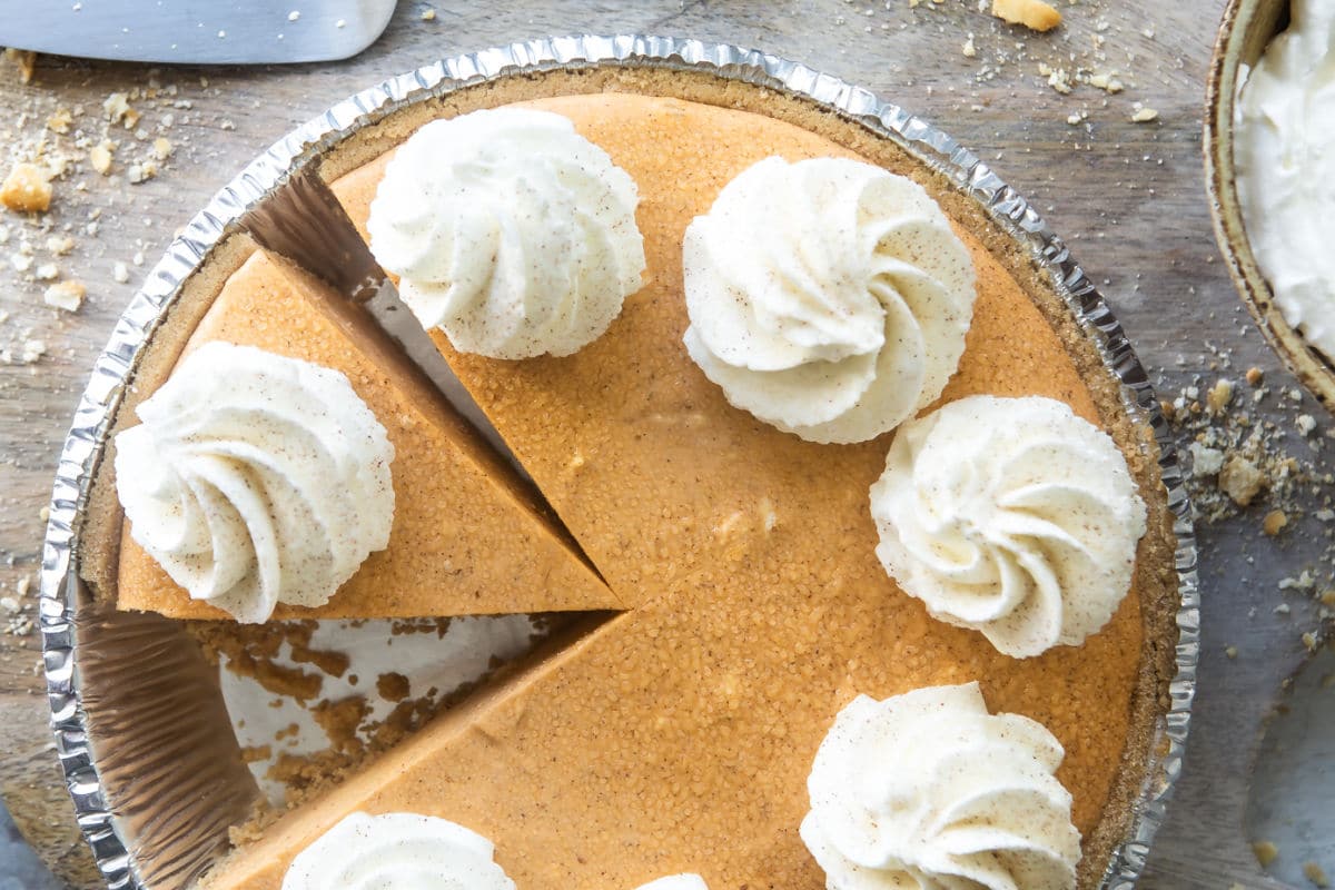 A no-bake pumpkin cheesecake with whipped cream on top.