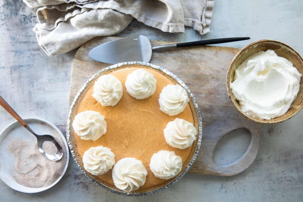 A no-bake pumpkin cheesecake with whipped cream on top.