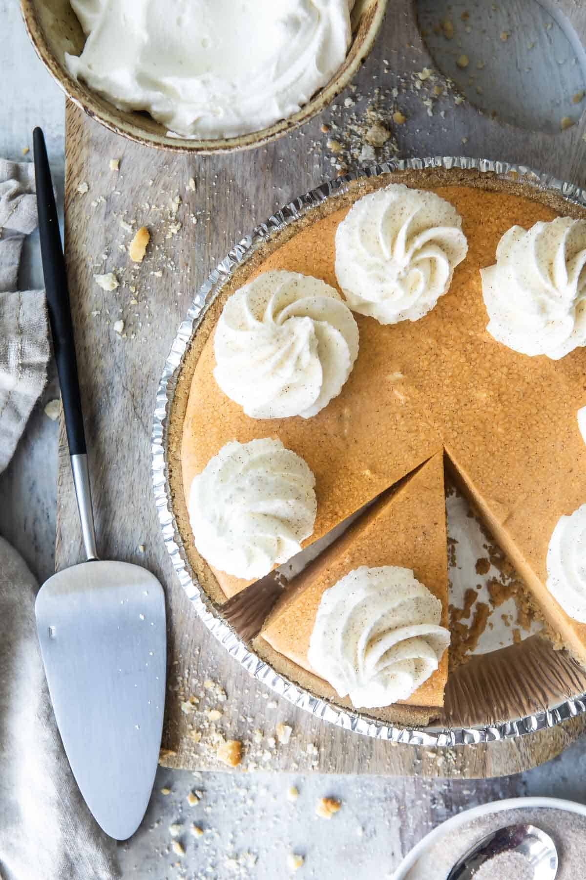 A no-bake pumpkin cheesecake with whipped cream on top.