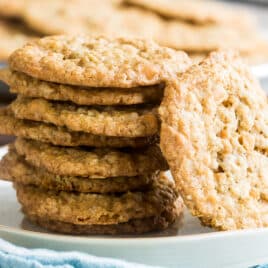 Oatmeal scotchies stacked on a white plate.