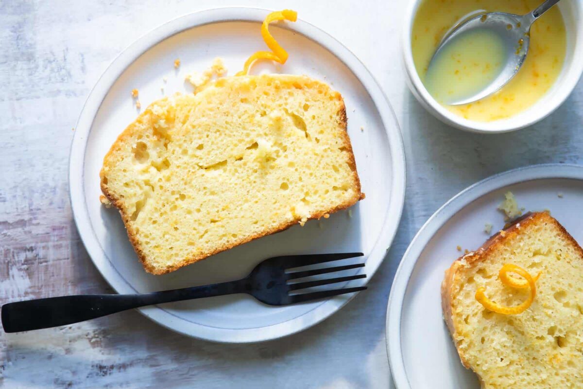 Slices of orange loaf cake on plates.