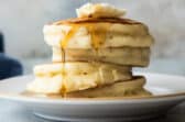 A stack of buttermilk pancakes on a plate.