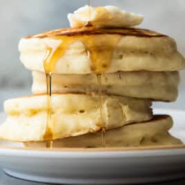 A stack of buttermilk pancakes on a plate.