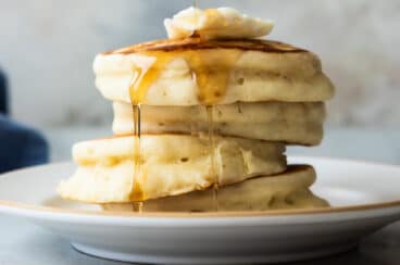 A stack of buttermilk pancakes on a plate.