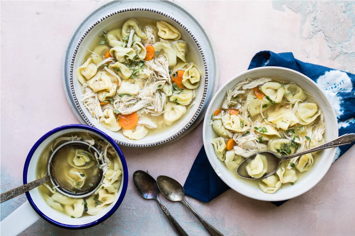 Slow cooker chicken tortellini soup in a white bowl.