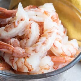 A bowl of peeled and deveined shrimp.
