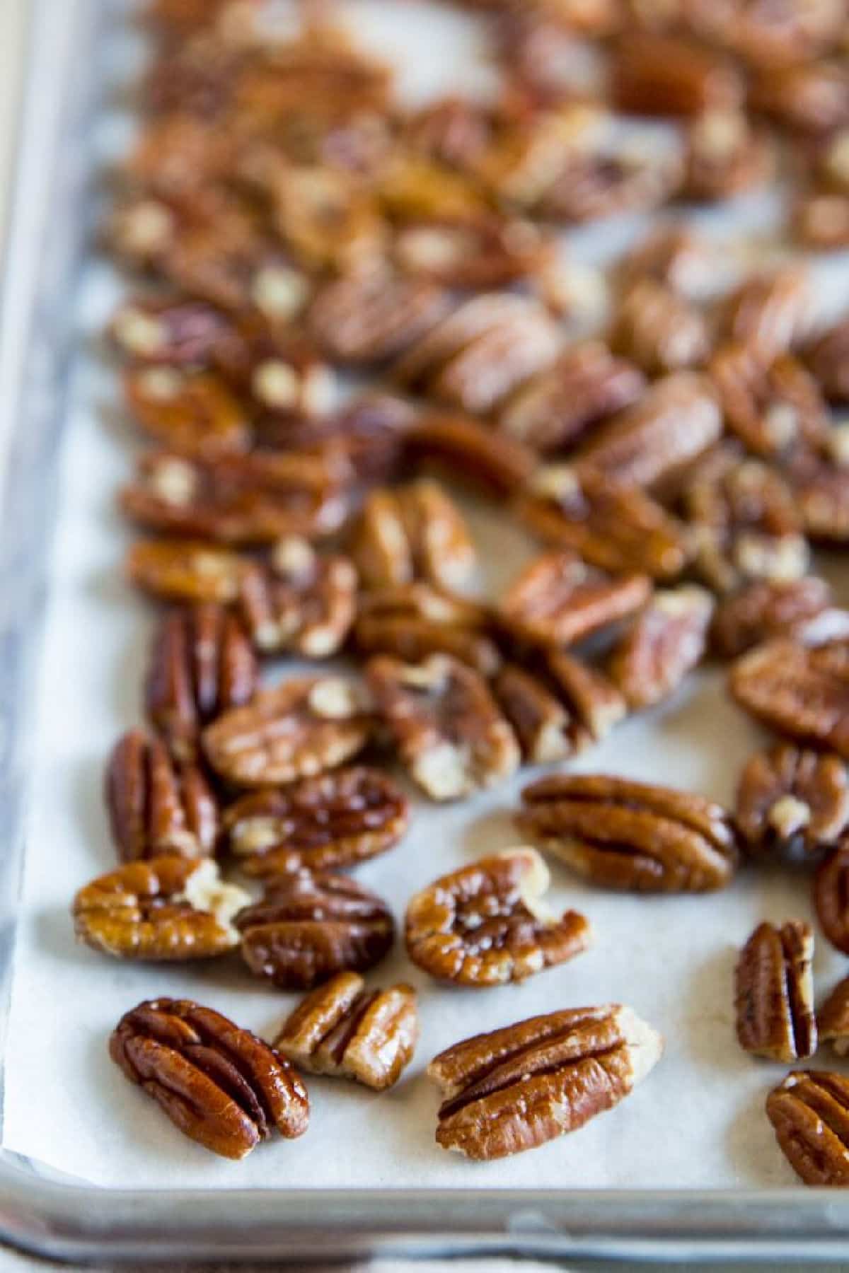 Toasted pecans on a baking sheet.