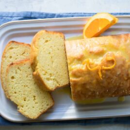 An orange cake on a serving platter.
