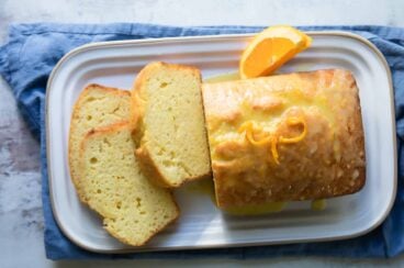 An orange cake on a serving platter.