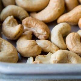 Roasted cashews on a baking sheet.
