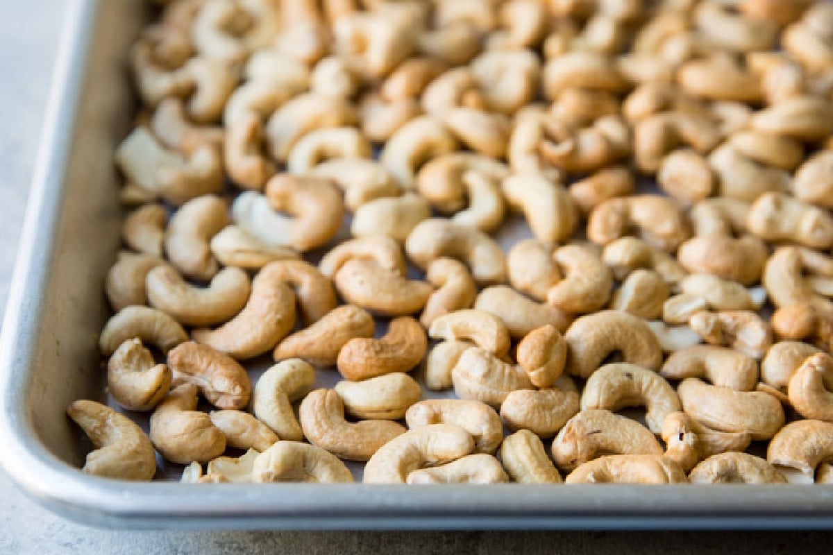 Roasted cashews on a baking sheet.