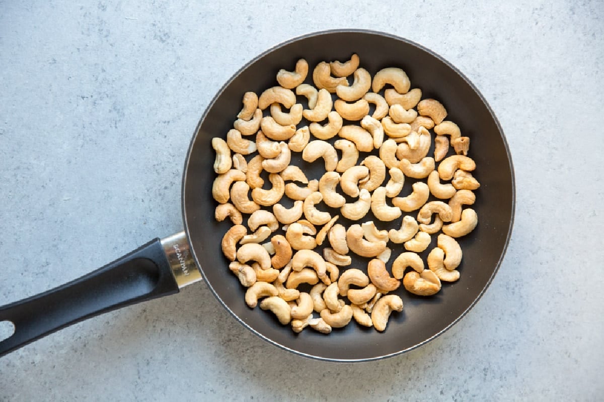 Roasted cashews in a skillet.