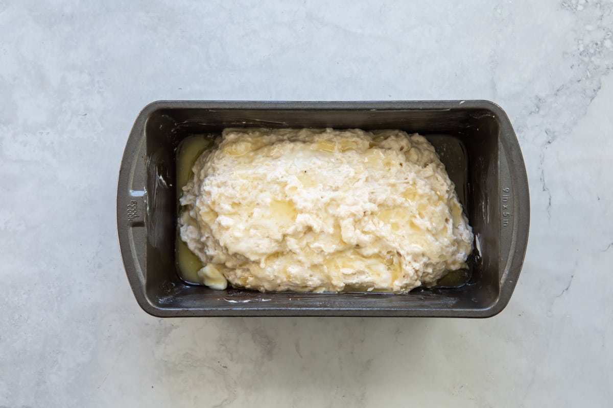An unbaked loaf of beer bread in a bread pan.