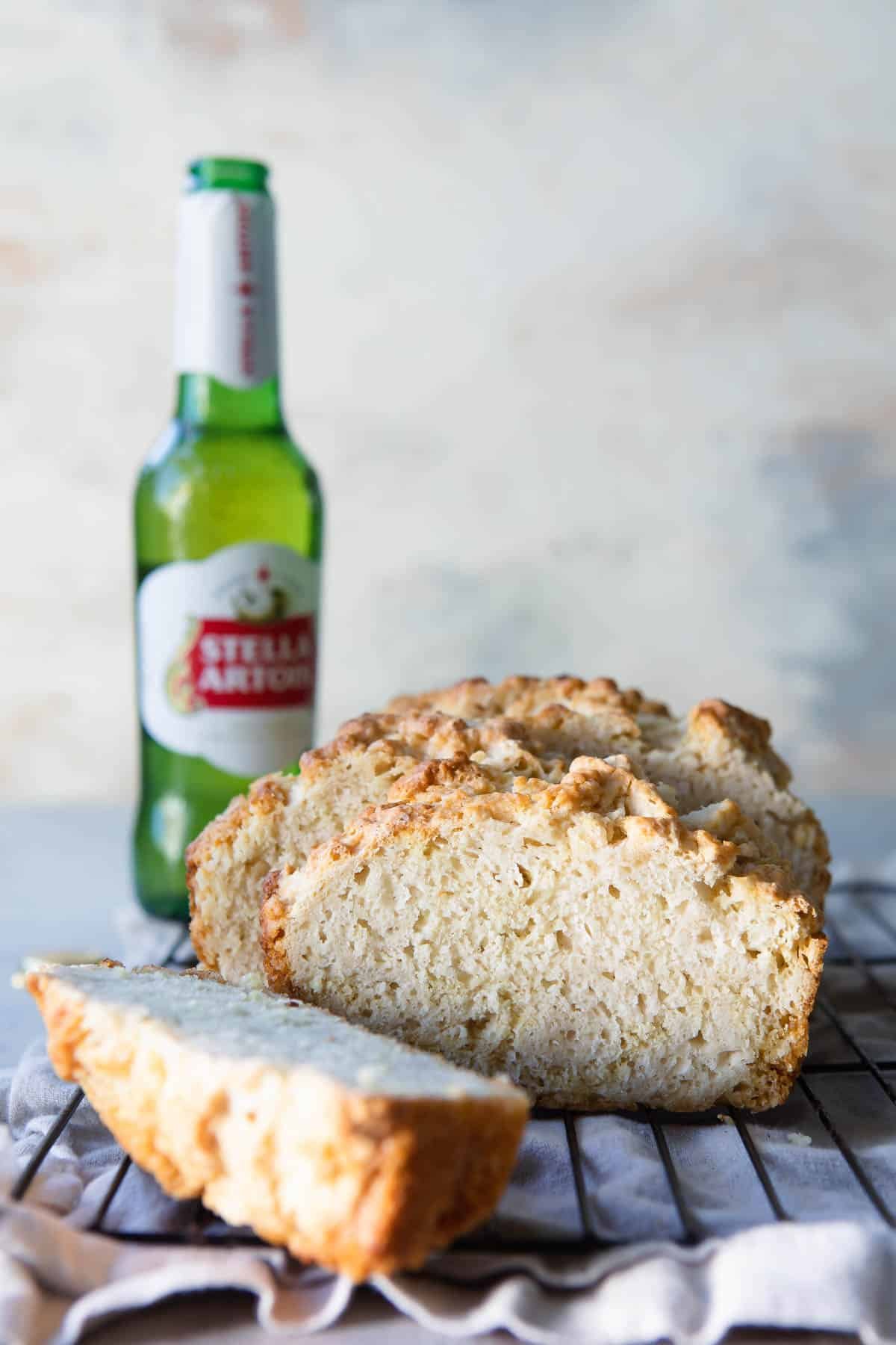 Sliced beer bread on a cooling rack.