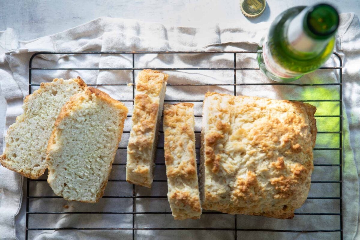 Sliced beer bread on a cooling rack.
