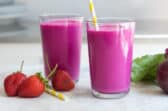 2 glasses of beet smoothie with straws.