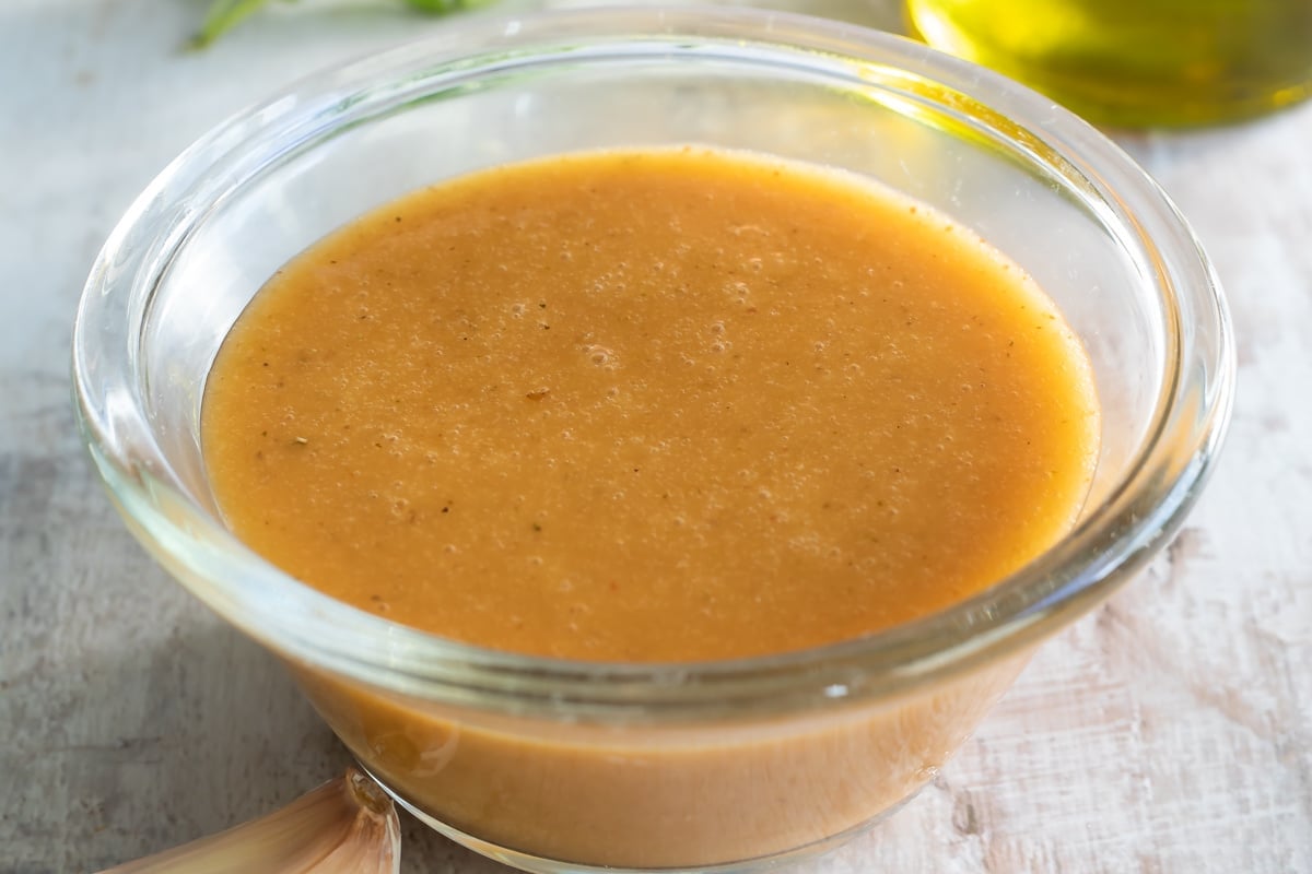 Chipotle vinaigrette in a clear bowl on a countertop.