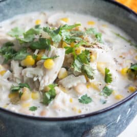 Slow cooker white chicken chili in a blue bowl.