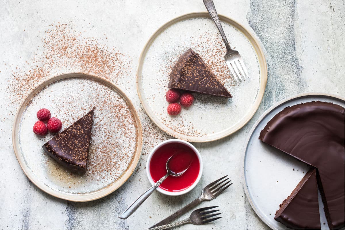 Flourless chocolate cake slice on a white plate.