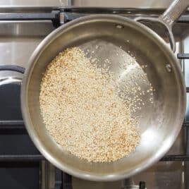 Sesame seeds toasting in a skillet.