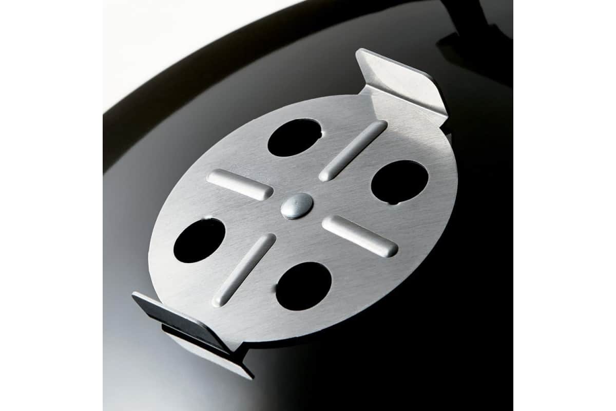 The vent on a charcoal smoker.