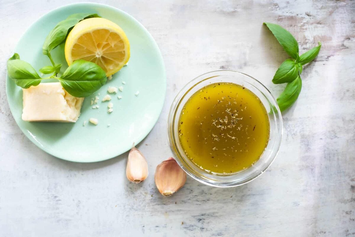 Italian dressing in a clear bowl on a countertop.