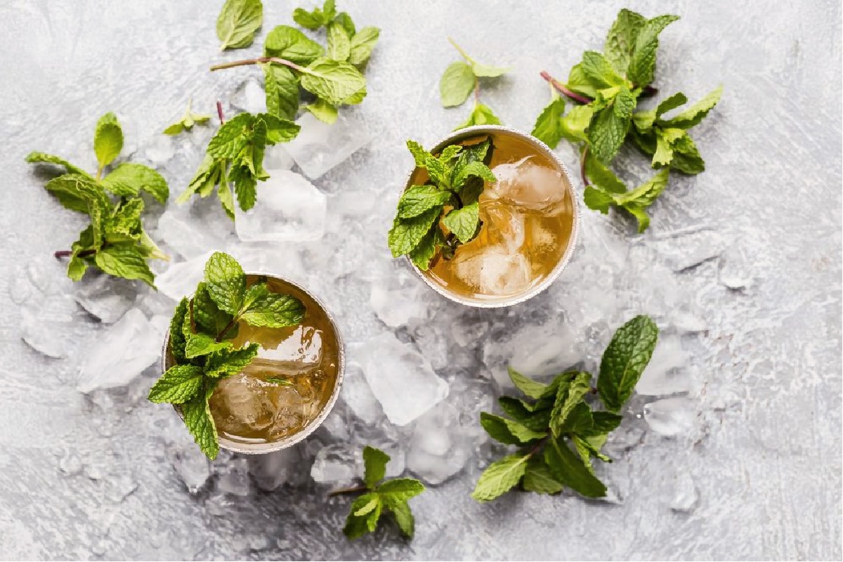 Two mint juleps in silver cups.