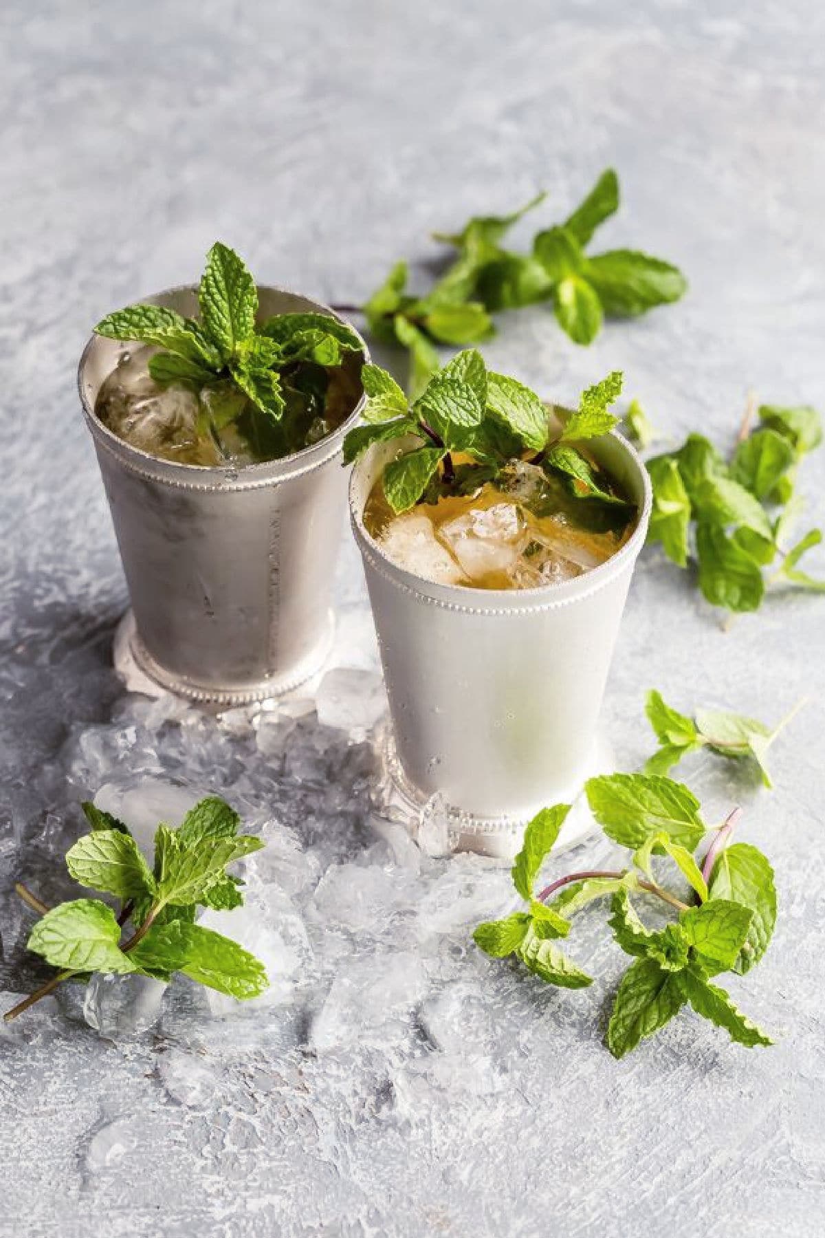 Two mint juleps in silver cups.
