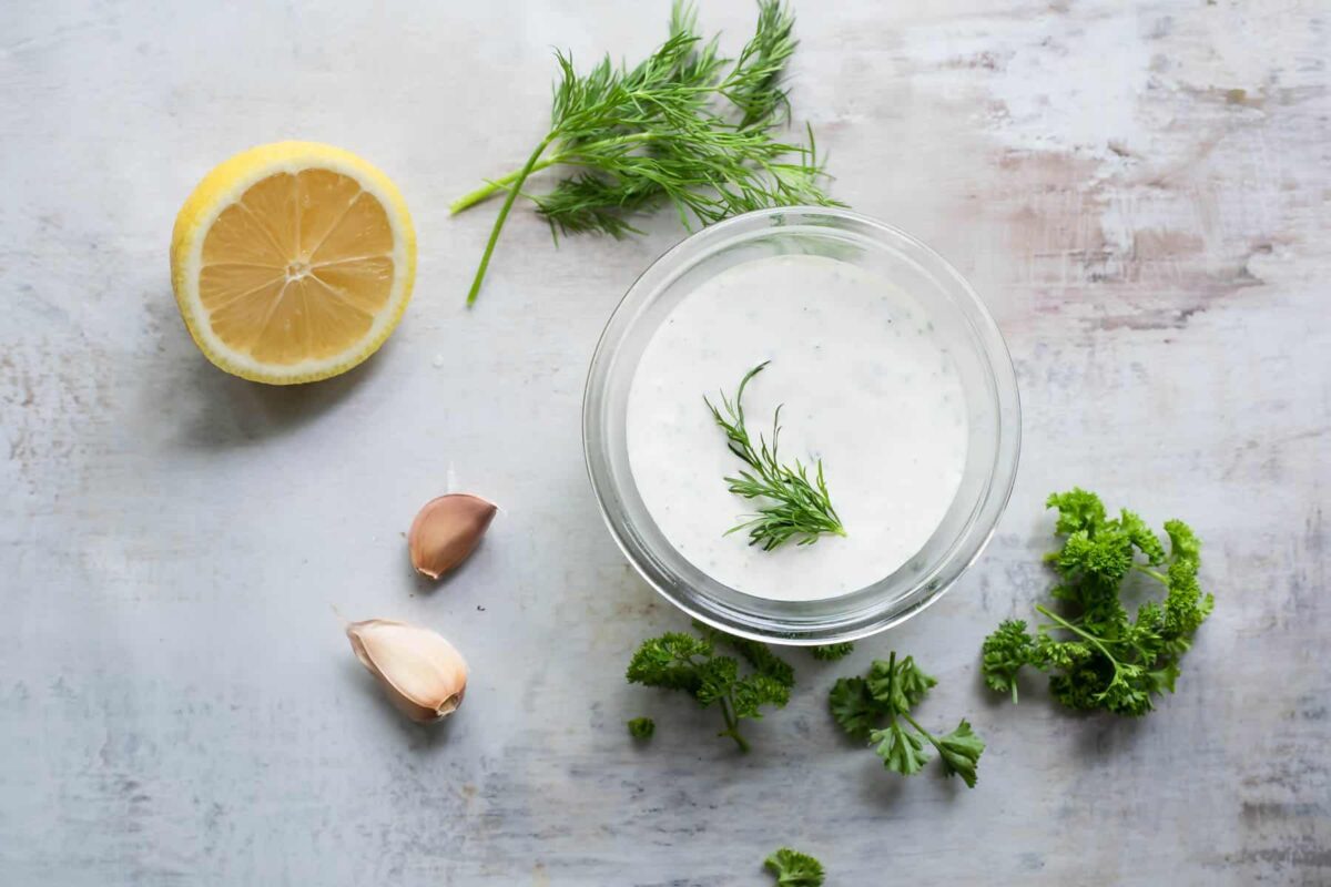 Ranch Dressing in a clear glass dish on a countertop.