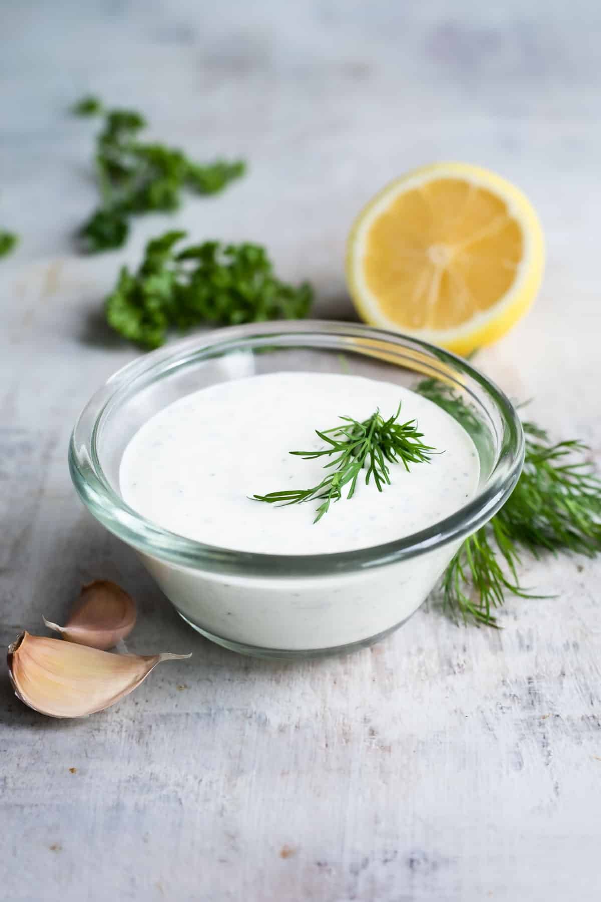Ranch Dressing in a clear glass dish on a countertop.