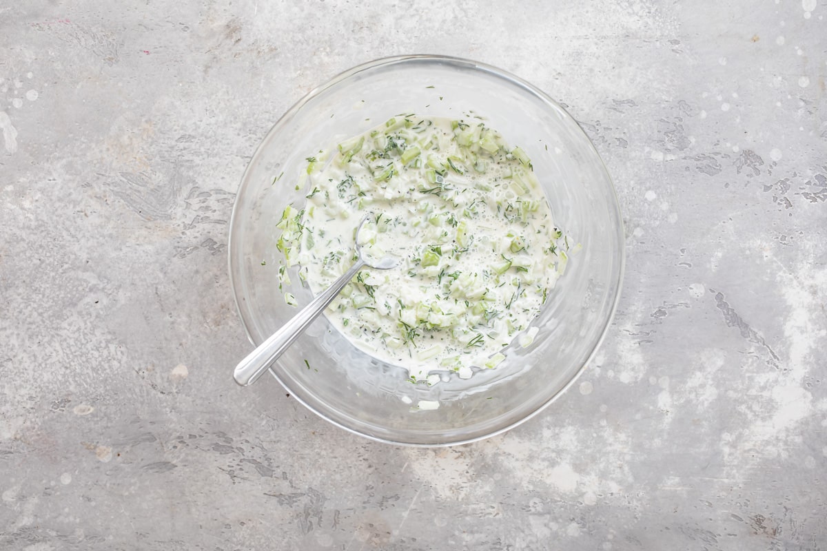 Shrimp salad dressing in a clear bowl.