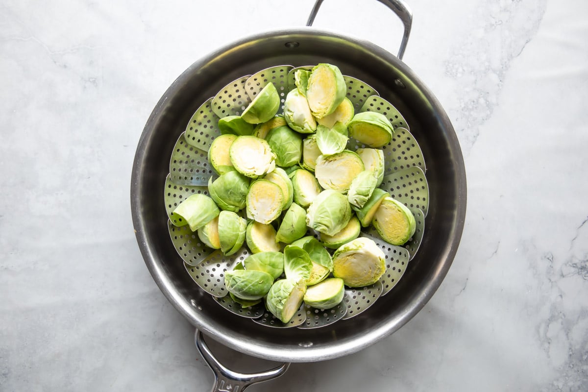 Raw Brussels sprouts before being steaming in a steamer basket.