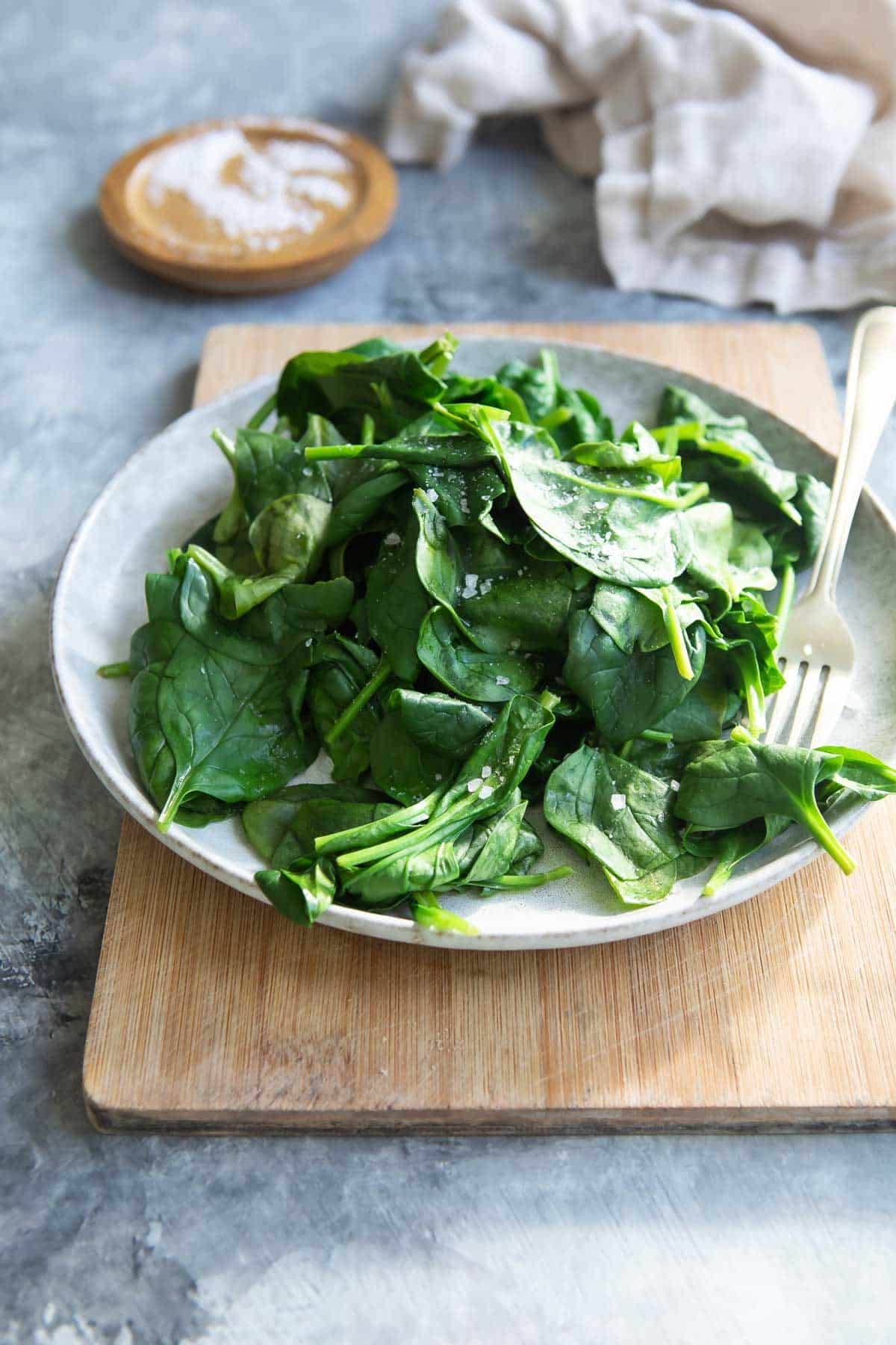 Steamed spinach on a gray plate.