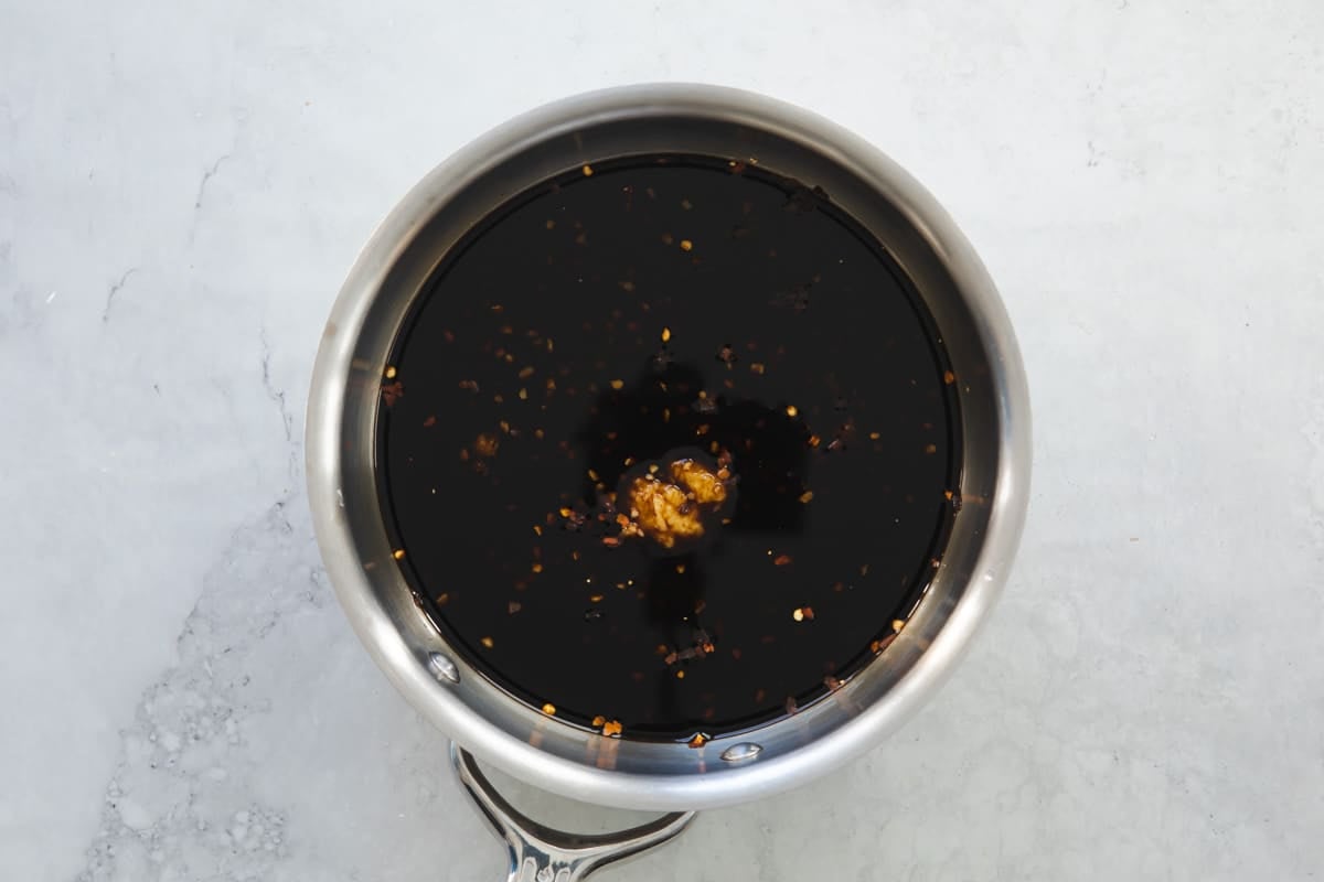 A small saucepan with teriyaki sauce.