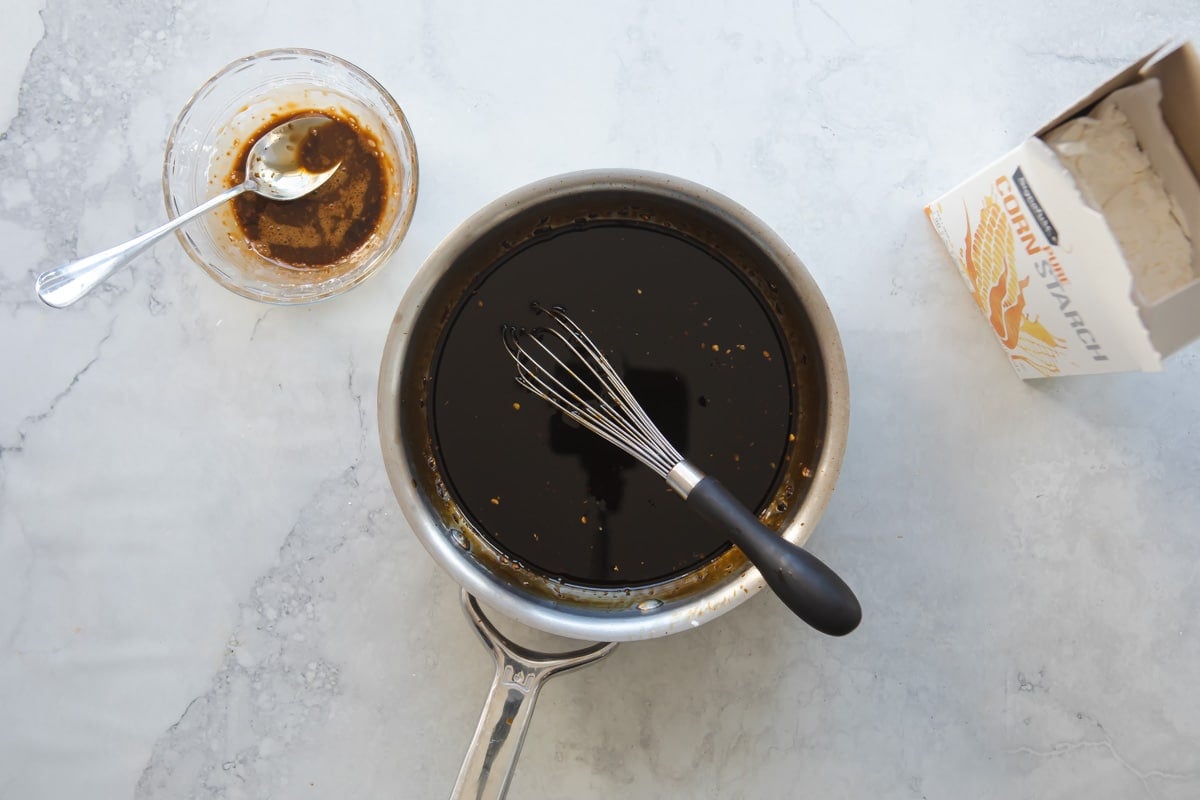 A small saucepan with teriyaki sauce.