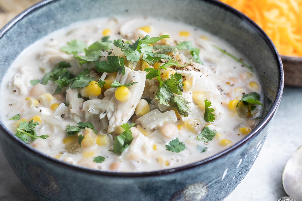 Slow cooker white turkey chili in a blue bowl.