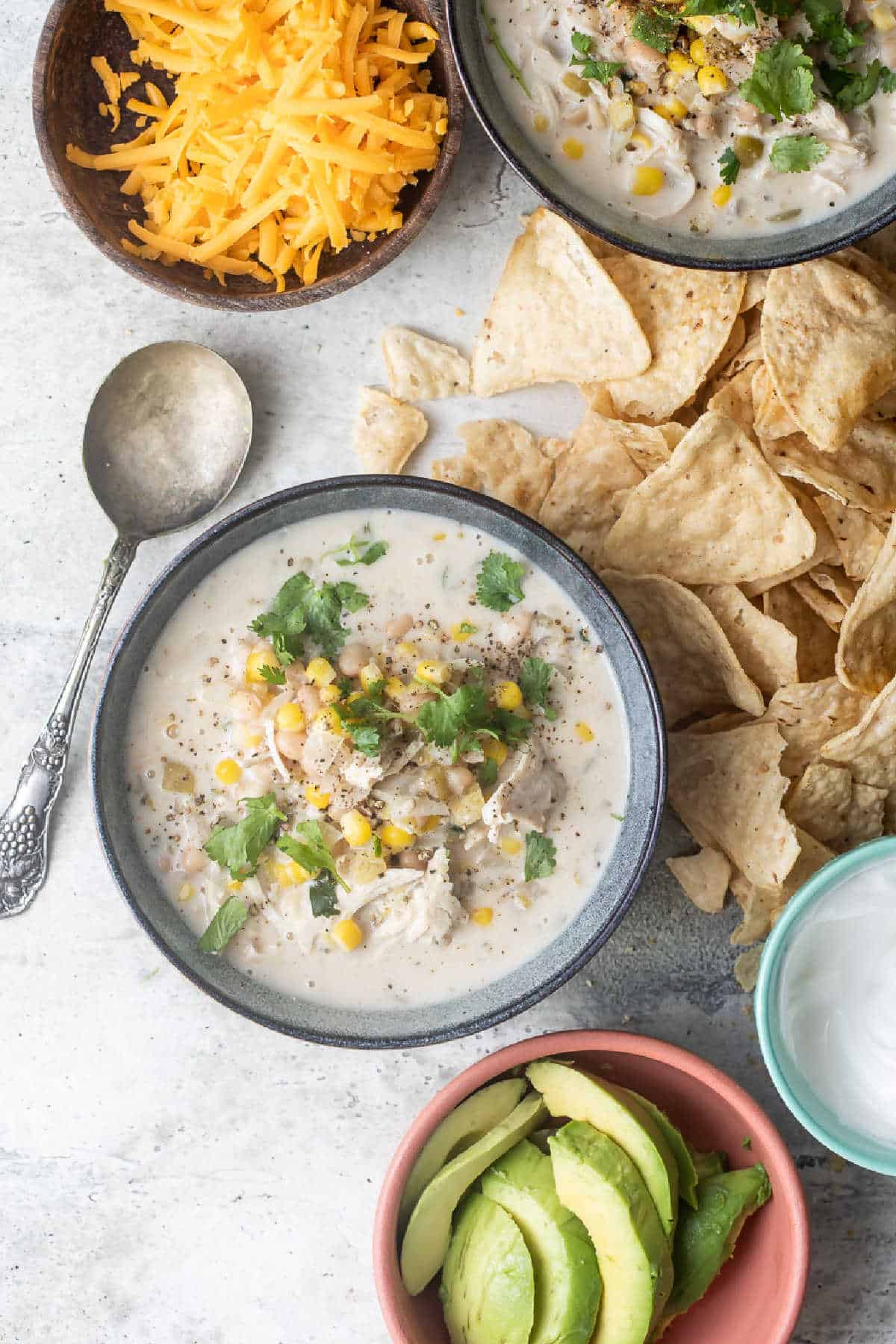Slow cooker white turkey chili in a blue bowl.