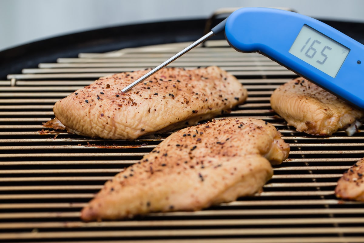 Smoked chicken breasts on a charcoal smoker.