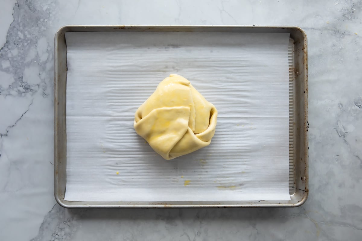 Wrapping a wheel of brie with apricot ja on top in puff pastry.
