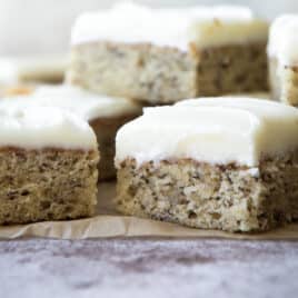 A pile of banana bars on a piece of parchment paper.