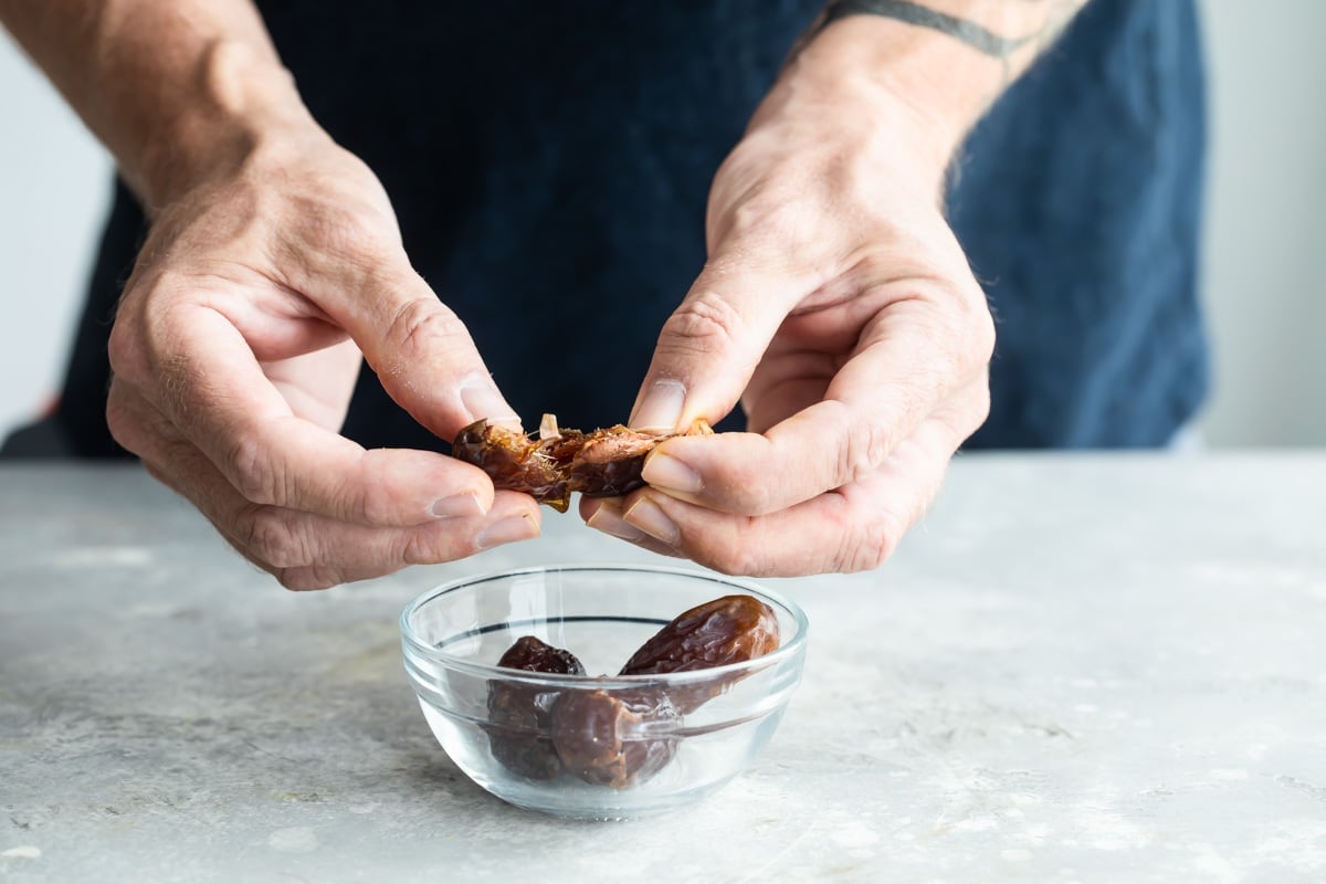 Pitting dried dates.