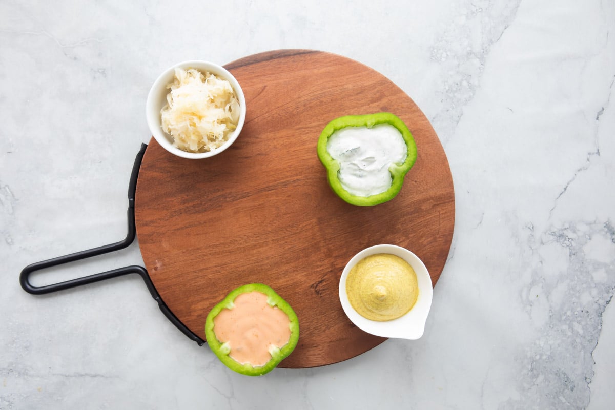 Dips and spreads on a St. Patrick's Day charcuterie board.