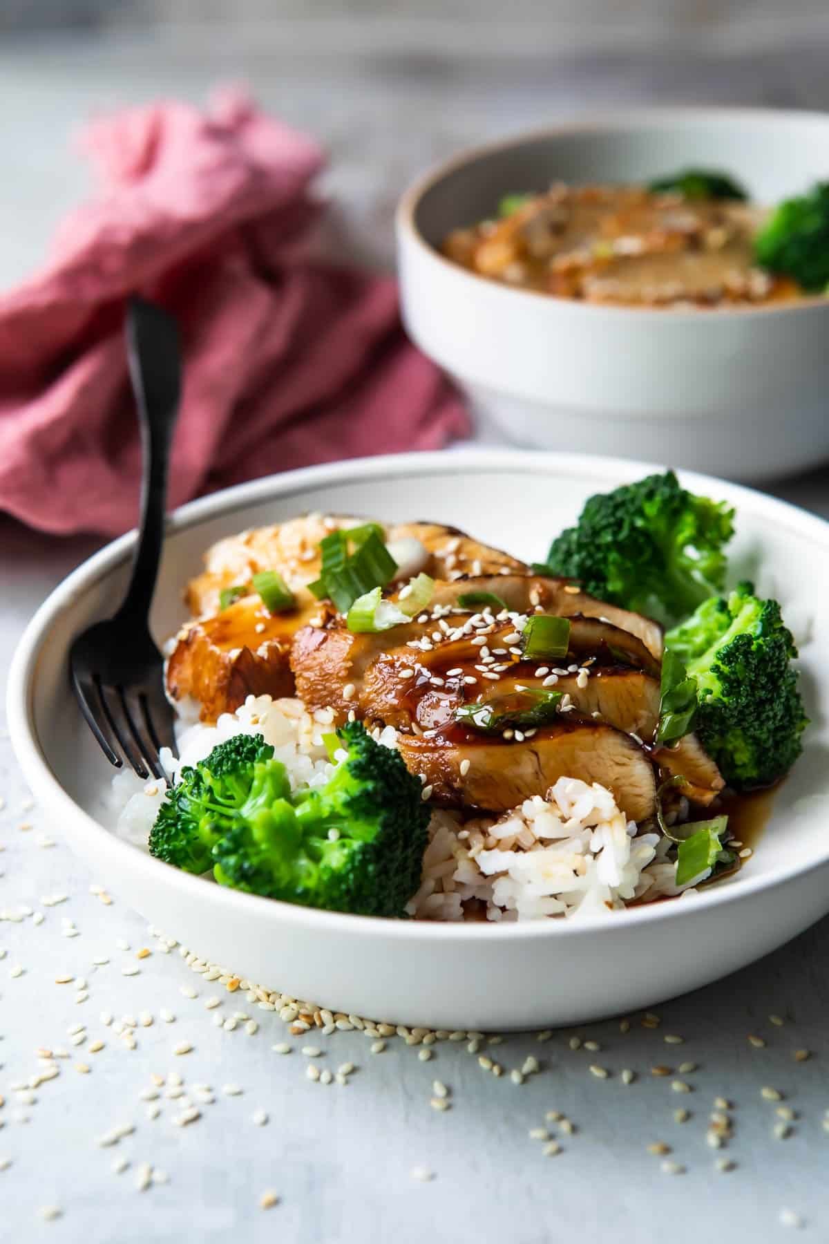 A plate of Teriyaki chicken with rice and steamed broccoli.