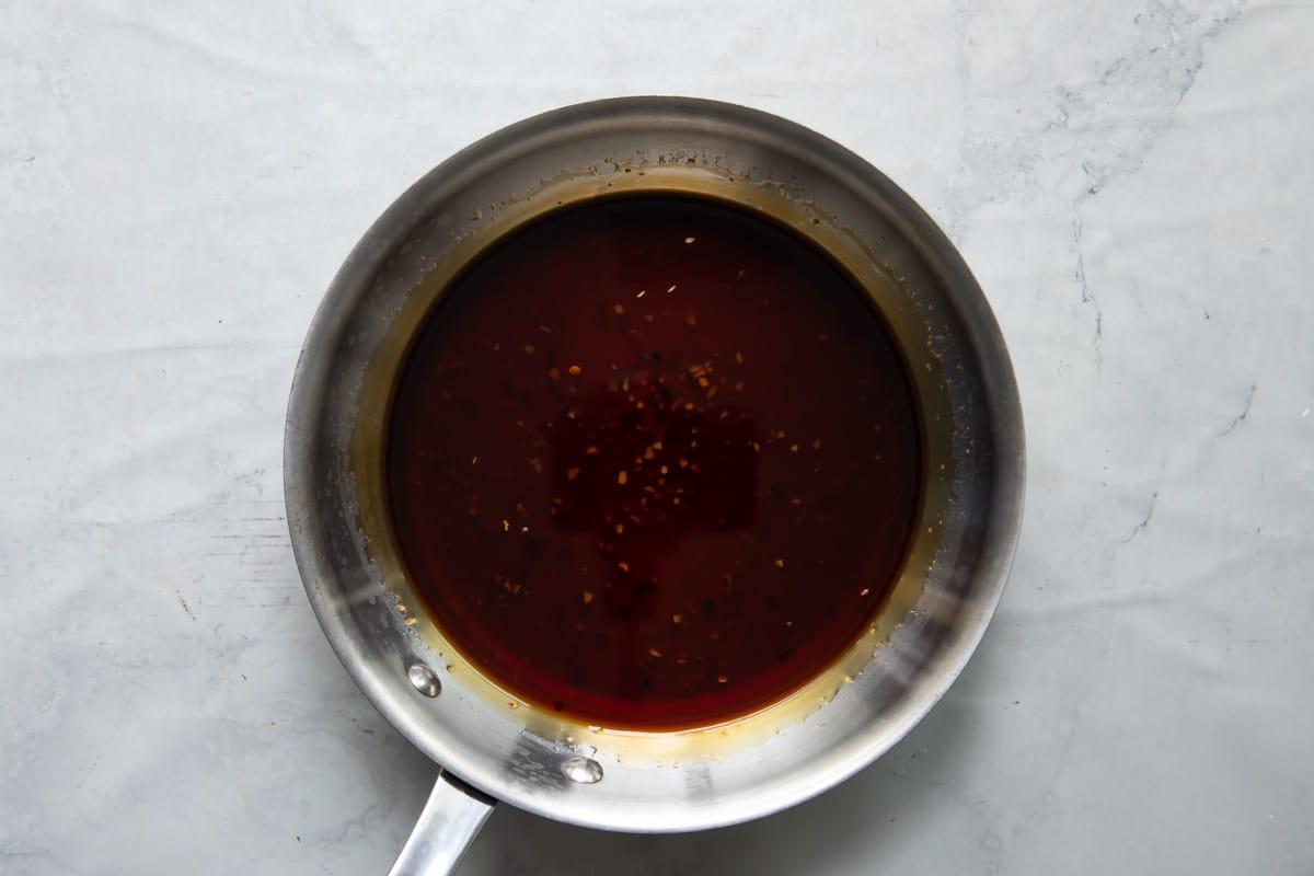 A skillet full of teriyaki sauce.