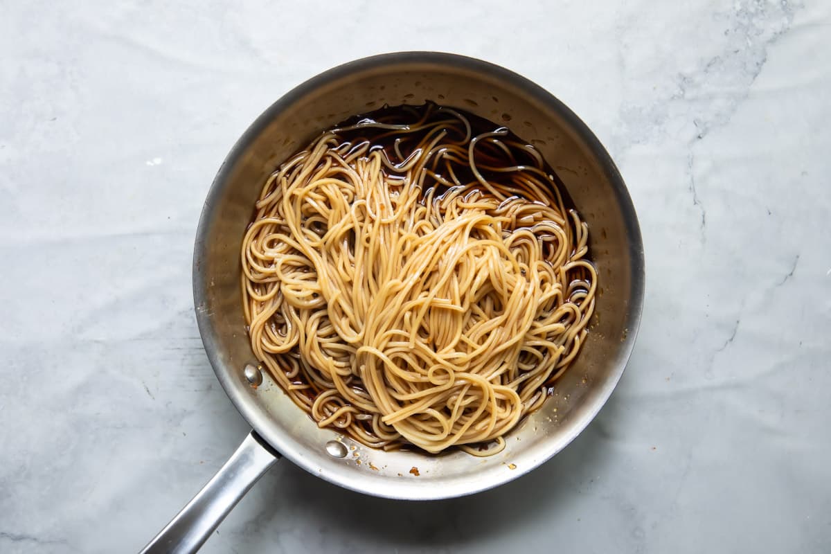 A skillet of teriyaki noodles.