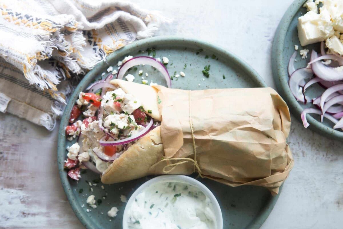 A chicken gyro on a blue plate.