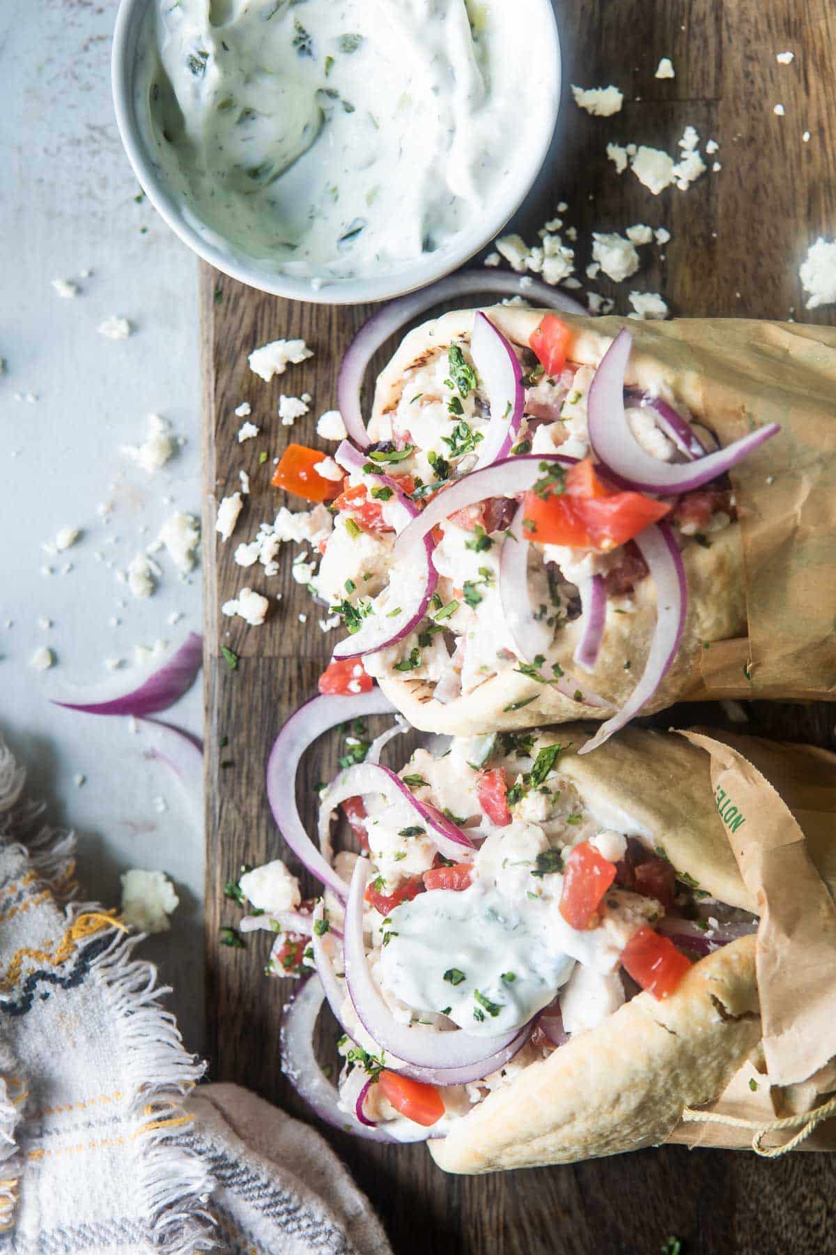 An shot of chicken gyros on a board.