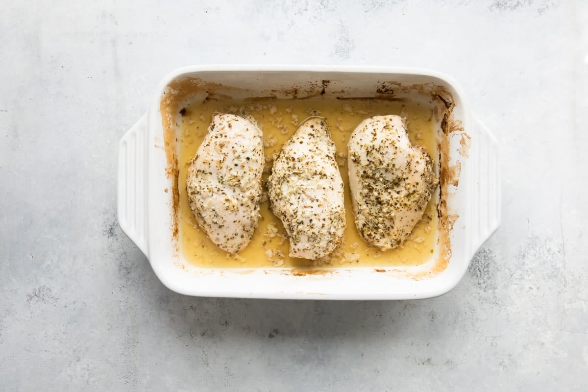 Baked Greek chicken in a baking dish.