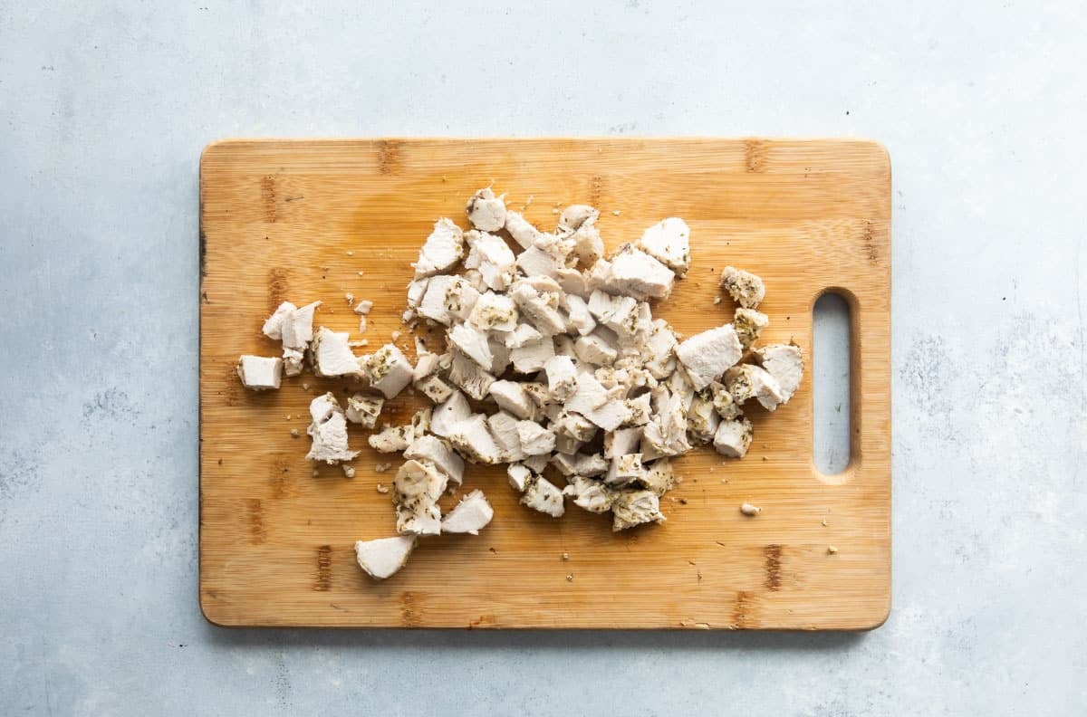 Chopped Greek chicken on a cutting board.